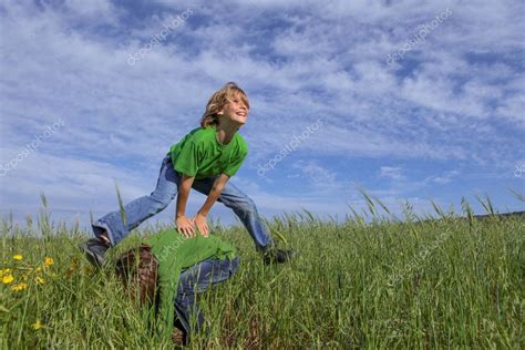 Kids playing leapfrog summer game Stock Photo by ©mandygodbehear 114731864