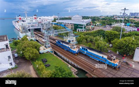 --FILE--Passenger trains runs to disembark from a ferry at the Nangang Port in Haikou city ...