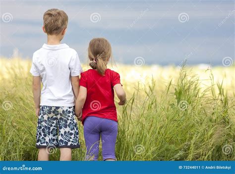 Little Boy and Little Girl Standing Holding Hands Looking on Horizont Stock Image - Image of ...