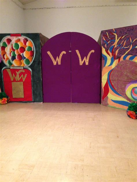 three brightly colored wooden doors with the letters w and w on them in front of a white wall