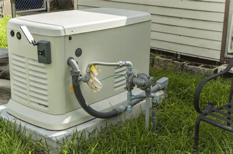 A Home Standby Generator Installed at the Backyard of a House. an Air ...