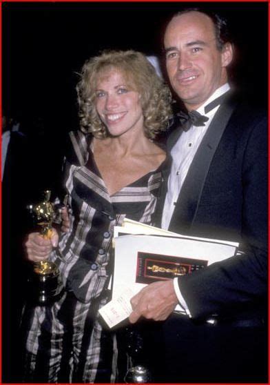 Carly Simon holding her Oscar for "Let the River Run" with Husband, Jim Hart.