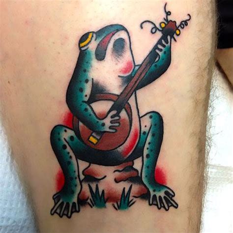 Cartoon Musician Frog Tattoo Idea