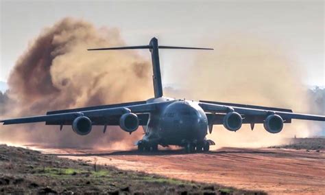 C-17 Dirt Airstrip Landing & Takeoff, Unloads AH-64. | AIIRSOURCE