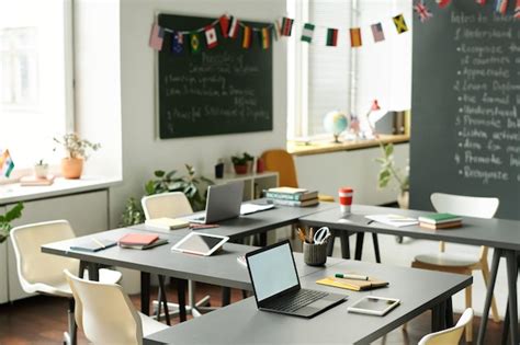 Premium Photo | Modern empty classroom with computers on table at school