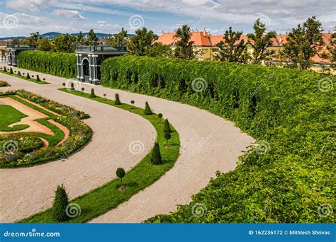 Urban Nature: Privy Garden in Majestic Schonbrunn Palace, Vienna Austria Against Orange Houses ...