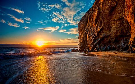 Sunset Serenity: HD Wallpaper of Ocean Cliffs and Sandy Beach