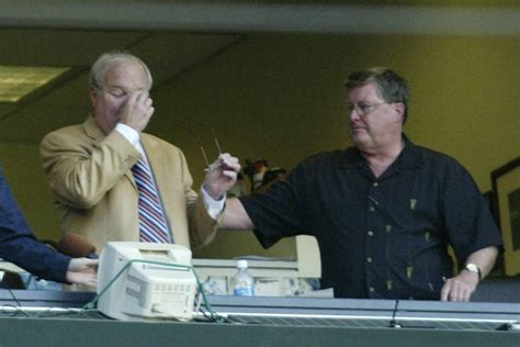 Seattle Mariners’ radio announcer Dave Neihaus, left, wipes his eyes as ...