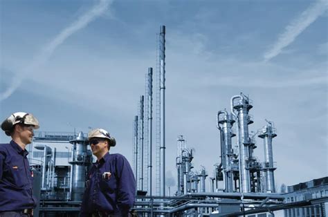 Oil and gas workers inside refinery industry Stock Photo by ©lagereek 104466846