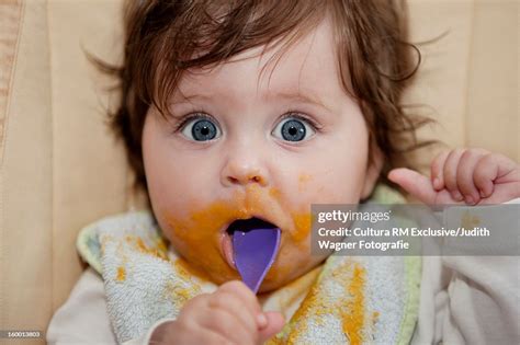 Surprised Baby Eating Messy Food High-Res Stock Photo - Getty Images