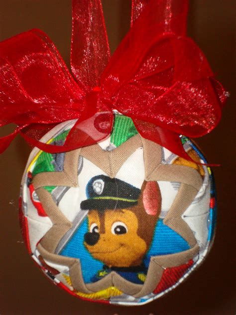 a christmas ornament with a paw patrol character hanging from it's side