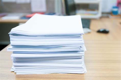 Premium Photo | Pile of a paper on office desk stacked.