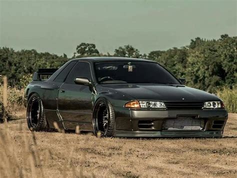 a black car parked in the middle of a field