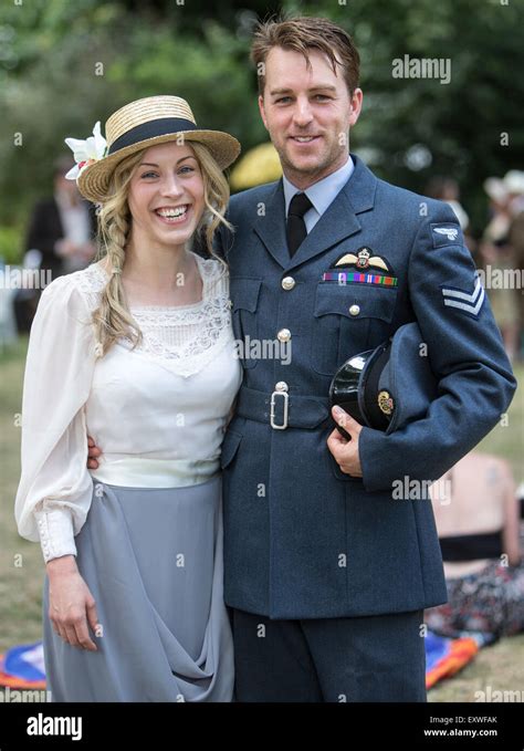 Picnic in the square with man in RAF uniform and Lady with boater Stock ...