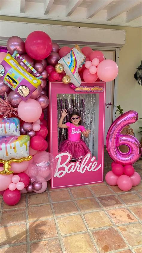 a barbie birthday party with balloons and decorations