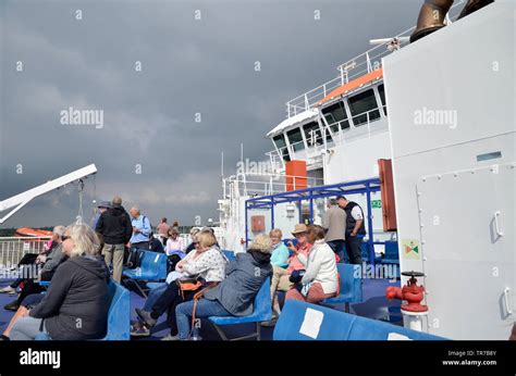 Passengers on a Wightlink ferry leaving the terminal at Lymington, Hampshire, bound for Yarmouth ...