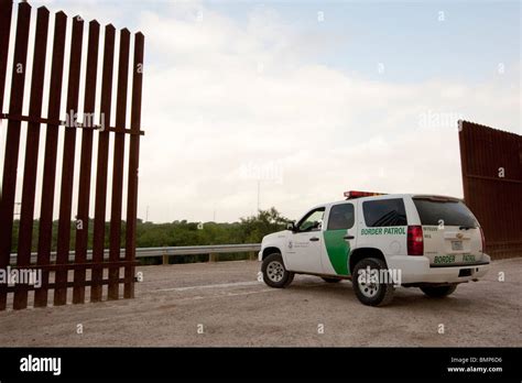 U.S. Border Patrol vehicle along the border wall between the United ...