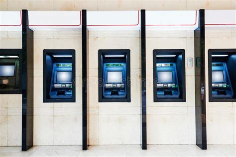 ATM machine in bank. A row of self servise ATM banking machines in a ...