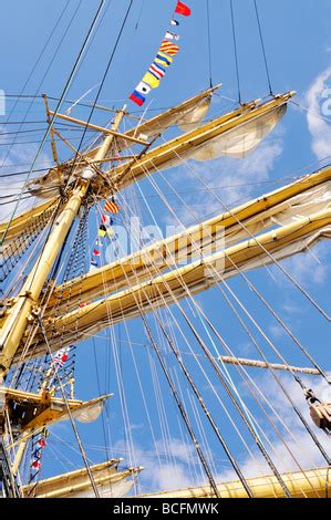 Sailboat yardarm with furled sail rigging and block and tackle Stock Photo - Alamy