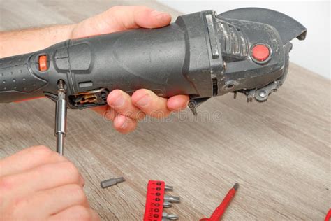 Power Tool Repair. an Engineer Repairing an Angle Grinder. Assembling ...