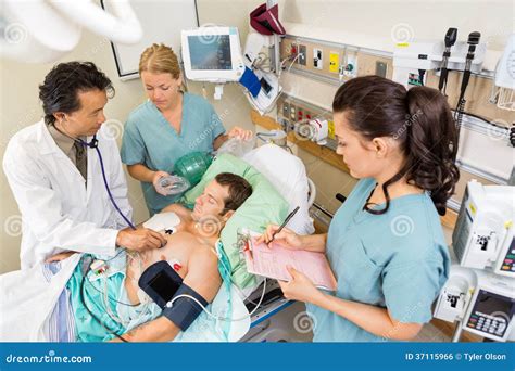 Doctor and Nurses Examining Patient in Hospital Stock Photo - Image of ...