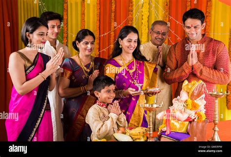 Indian family performing ganesh puja on ganesh chaturthi or ganesh festival at home Stock Photo ...