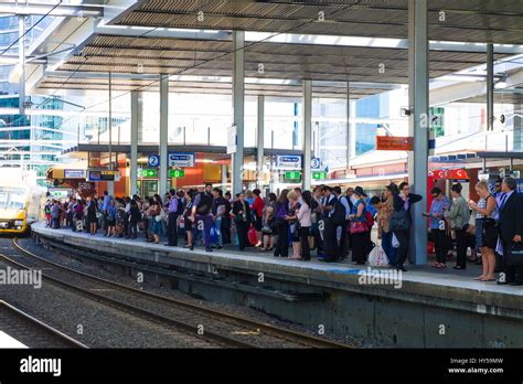 Rail commuters waiting: crowded platform at Parramatta Station, Sydney, Australia. Peak hour ...