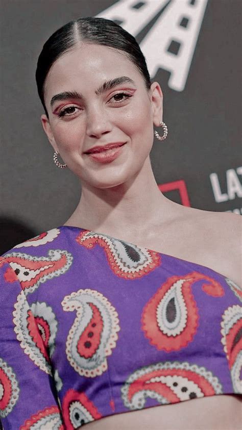 a woman in a purple dress smiling at the camera