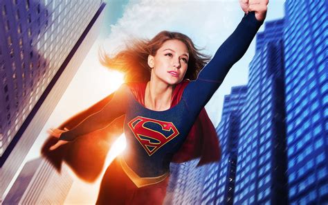 Supergirl flying between highrise building HD wallpaper | Wallpaper Flare