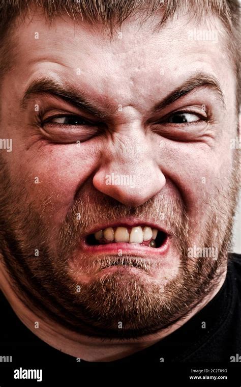 Portrait of strange man making stupid angry face Stock Photo - Alamy