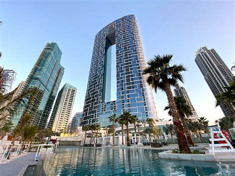 killa design tops 'address' beach resort towers with bridging infinity pool