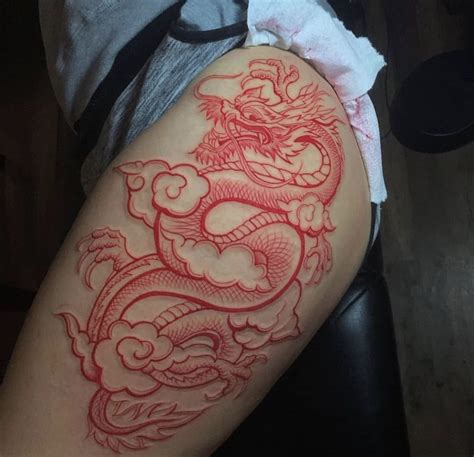 red dragon tattoo on thigh | Dragon thigh tattoo, Hip thigh tattoos, Red tattoos