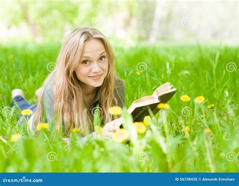 Girl Lying on Grass with Dandelions Reading a Book Stock Image - Image ...