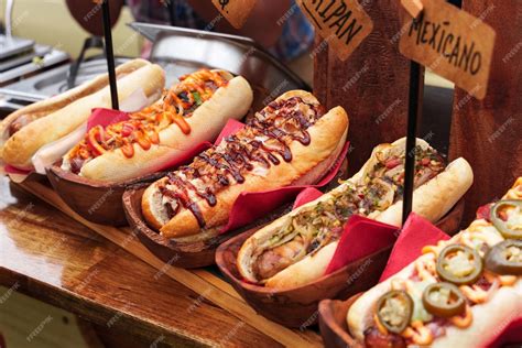 Premium Photo | Many hot dogs with various toppings and sauces Grilled ...