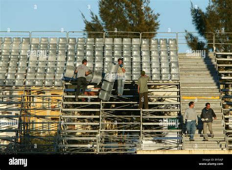 Men installing seats at a football stadium Stock Photo - Alamy