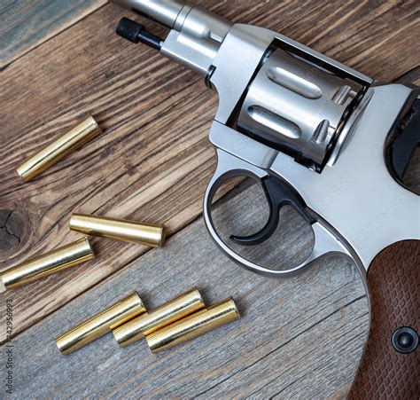 Silver revolver with cartridges Stock Photo | Adobe Stock