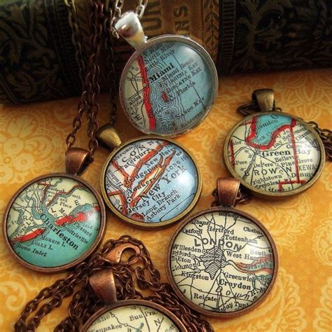 four pendants with maps on them sitting on a table