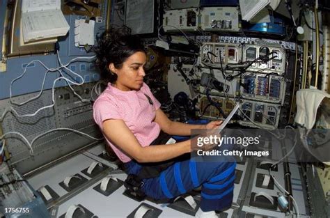 Astronaut Kalpana Chawla, STS-107 mission specialist, looks over a... News Photo - Getty Images