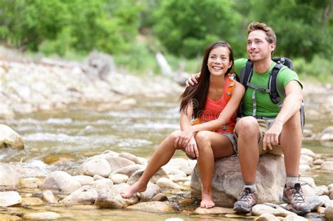 Hiking couple - hikers resting in Zion Park. Hiking couple - hikers resting… | Gatlinburg hotels ...