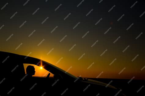 Premium Photo | Silhouette of sedan car on the background of beautiful ...