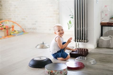 funny child Toddler drumming on pots and pans, crashing child playing drums with kitchen ...