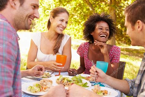 Four friends eating together — Stock Photo © monkeybusiness #98224318