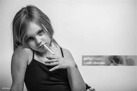 Portrait Young Girl With Cigarette In Mouth Looking At Camera High-Res ...