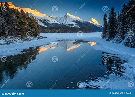 The Frozen Maligne Lake with Queen Elizabeth Ranges in the Background in the Jasper National ...