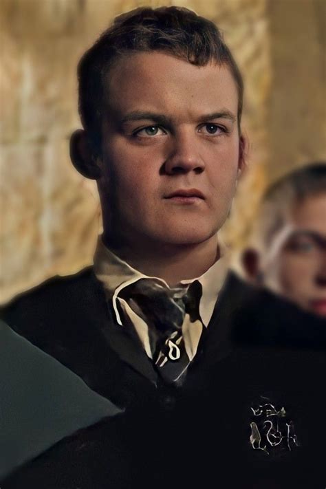 a young man wearing a black vest and tie