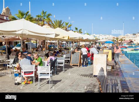 Outdoor cafes and Fish Restaurants on waterfront Marsaxlokk Harbour Malta EU Europe Stock Photo ...