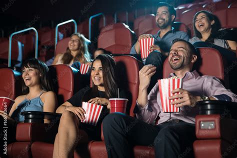 Group of people laughing at the movie theater Stock Photo | Adobe Stock