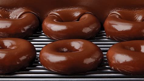 Krispy Kreme baking up chocolate glazed doughnuts on first...