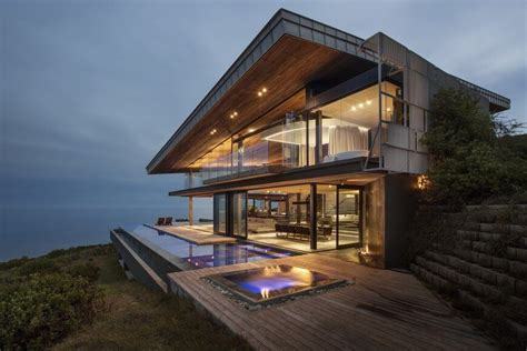 Check out this incredible modern wood, glass and concrete home by SAOTA. It sits on a cliff top ...