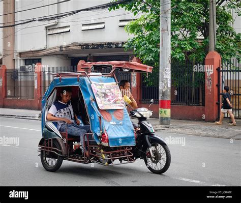 Manila, Philippines - Dec 20, 2015. People riding tricycle on street in Manila, Philippines ...